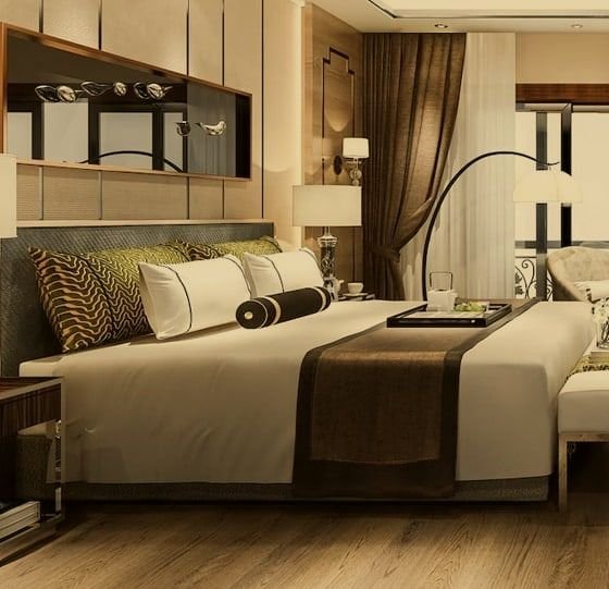 Conceptual bed with cushions and bedside lamps, in a warm grade. Not the actual project.